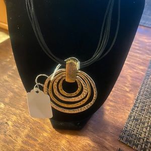 Leather necklace with silver two tone pendant